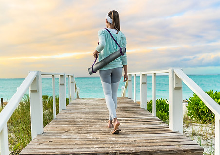 Woman carrying yoga mat