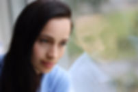 tired-woman-looks-out-window.jpg