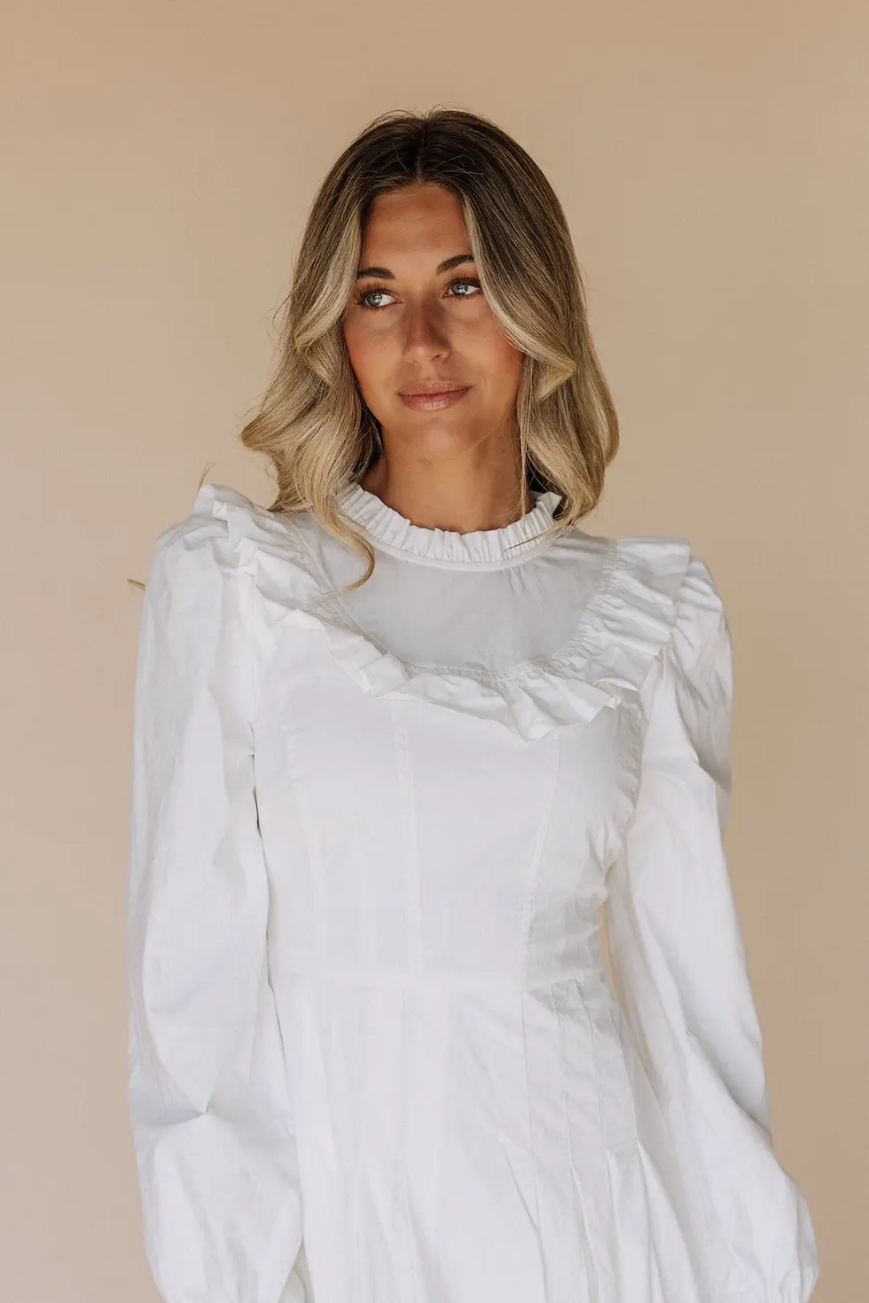 Close-up of the ruffled hem and functional pockets on the Nauvoo white temple dress