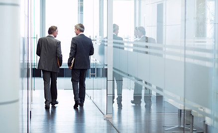 Business Meeting of Two Men Walking in the Hall