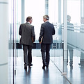 Business Meeting of Two Men Walking in the Hall