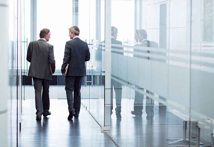 Business Meeting of Two Men Walking in the Hall