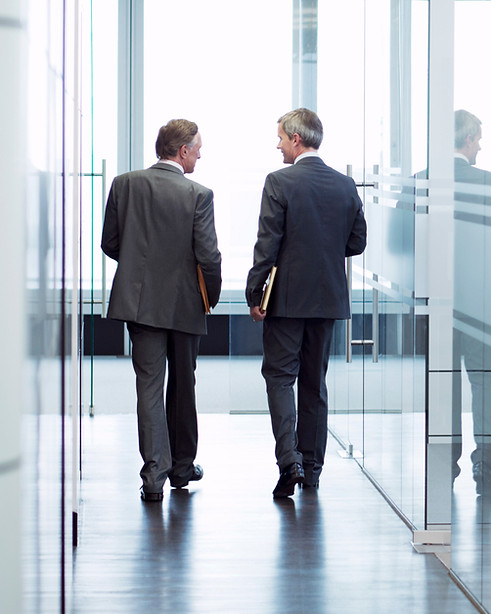 Business Meeting of Two Men Walking in the Hall