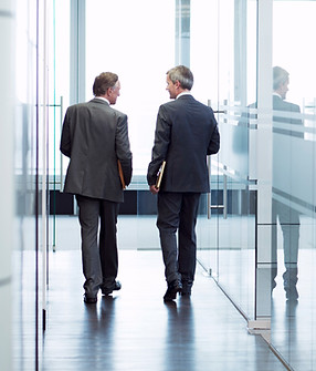Business Meeting of Two Men Walking in the Hall