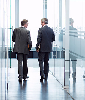Business Meeting of Two Men Walking in the Hall