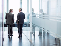 Business Meeting of Two Men Walking in the Hall