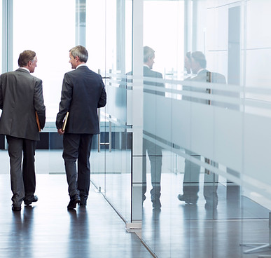 Business Meeting of Two Men Walking in t