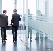 Business Meeting of Two Men Walking in the Hall