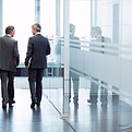 Business Meeting of Two Men Walking in the Hall