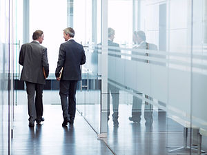 Business Meeting of Two Men Walking in the Hall