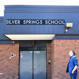 Dan Olesen outside a local Calgary elementary school, focused on education and family-centered policy