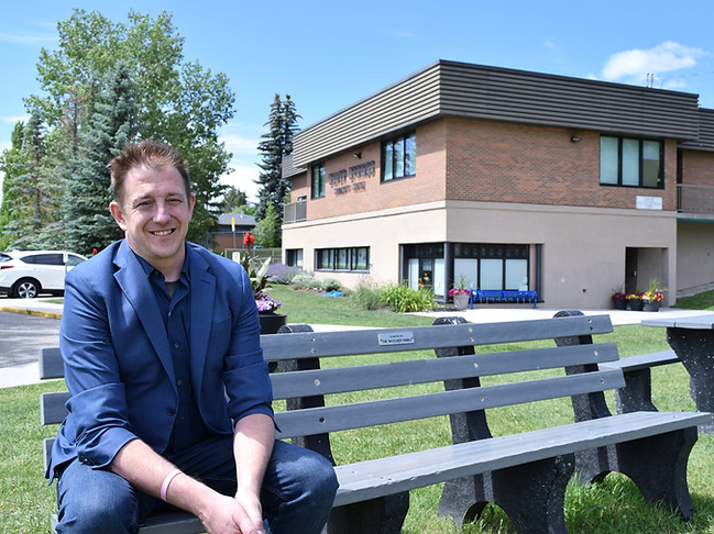 Dan Olesen sitting outside Silver Springs Community Hall, ready to connect