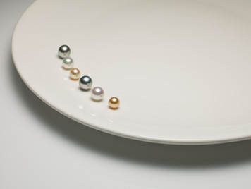 APJ Pearls Photography with six pearls on white plate
