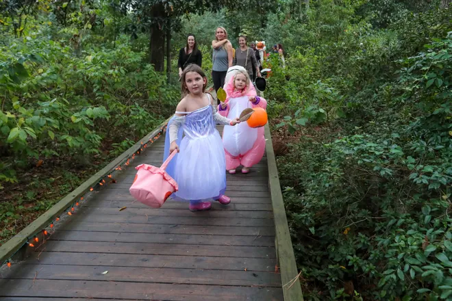 Trick or treaters move along the trail during the annual Oatland Island Halloween Hike on Friday, October 13, 2023. Richard Burkhart/Savannah Morning News