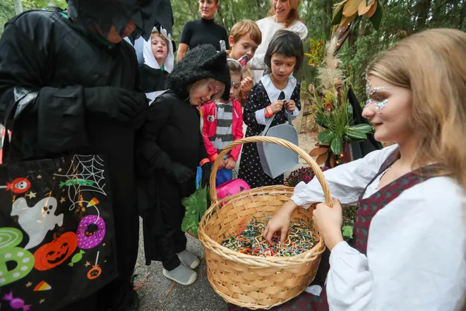 Mother Earth passes out a friend for trick or treaters to carry on their journey during the annual Oatland Island Halloween Hike on Friday, October 13, 2023. Richard Burkhart/Savannah Morning News