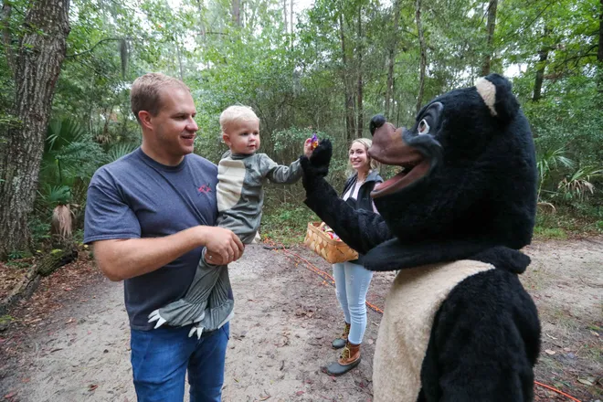 A young trick or treater gives a high five during the annual Oatland Island Halloween Hike on Friday, October 13, 2023. Richard Burkhart/Savannah Morning News