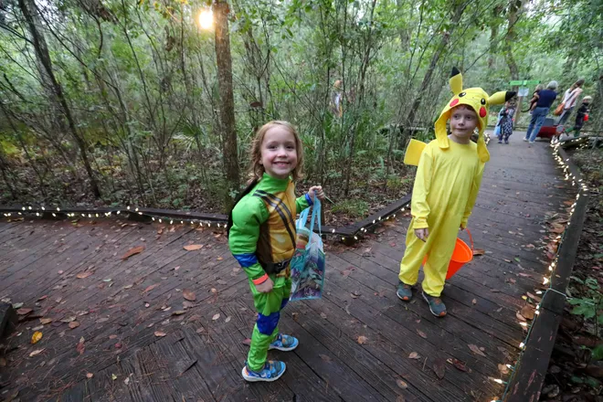 Young trick or treaters are all smiles as they make their way around the trail during the annual Oatland Island Halloween Hike on Friday, October 13, 2023. Richard Burkhart/Savannah Morning News