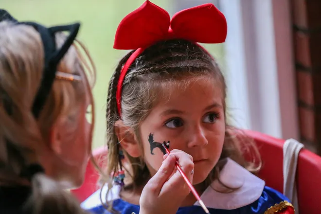 Tully Greene has a cat painted on her face during the annual Oatland Island Halloween Hike on Friday, October 13, 2023. Richard Burkhart/Savannah Morning News