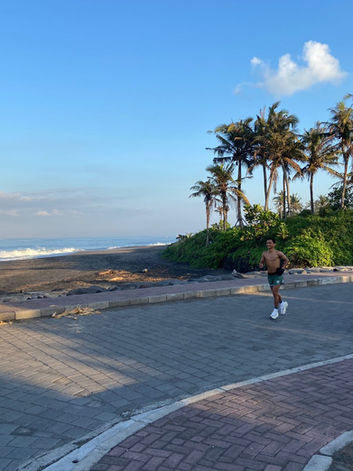 Jogger exercising along the beach in the morning in Pererenan, Bali