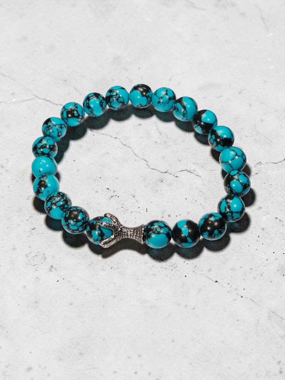 Turquoise beaded bracelet with silver claw charm