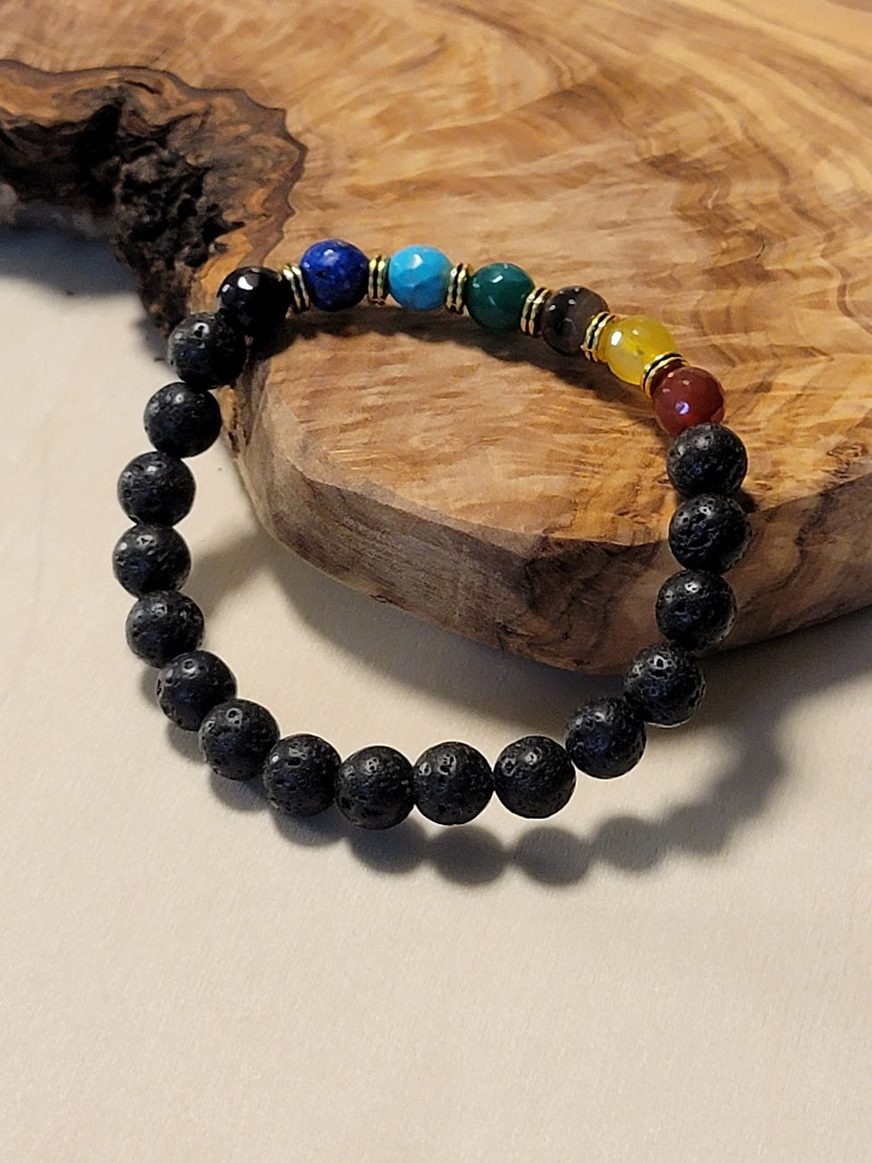 Beaded chakra bracelet on wood