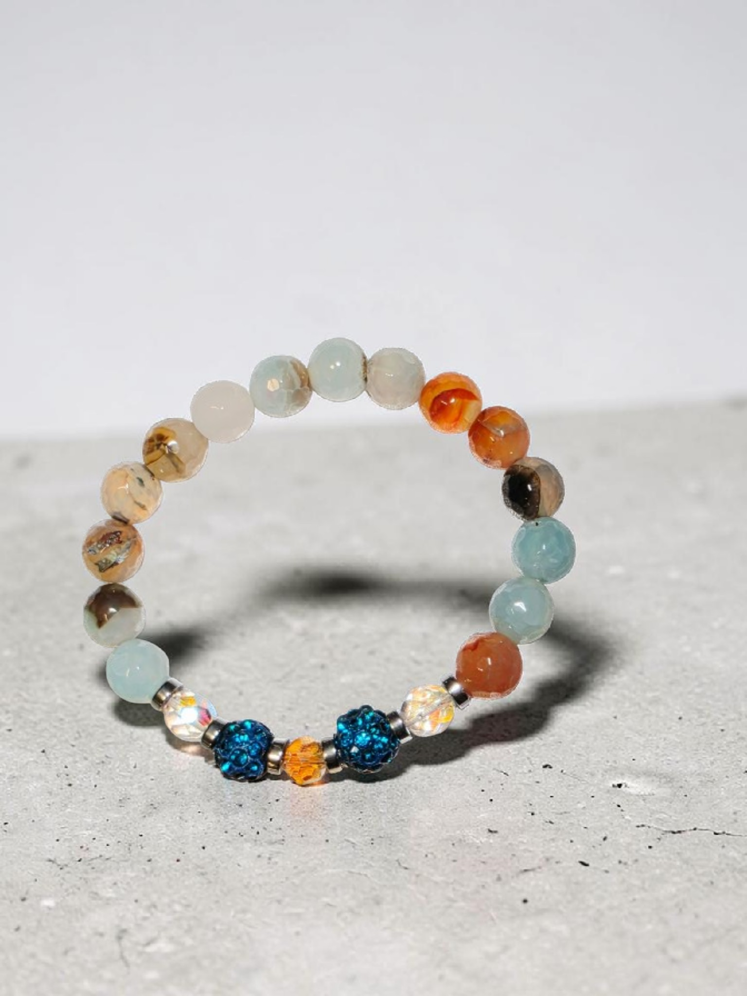 Vibrant multi-colored stretch bracelet with sparkling blue beads