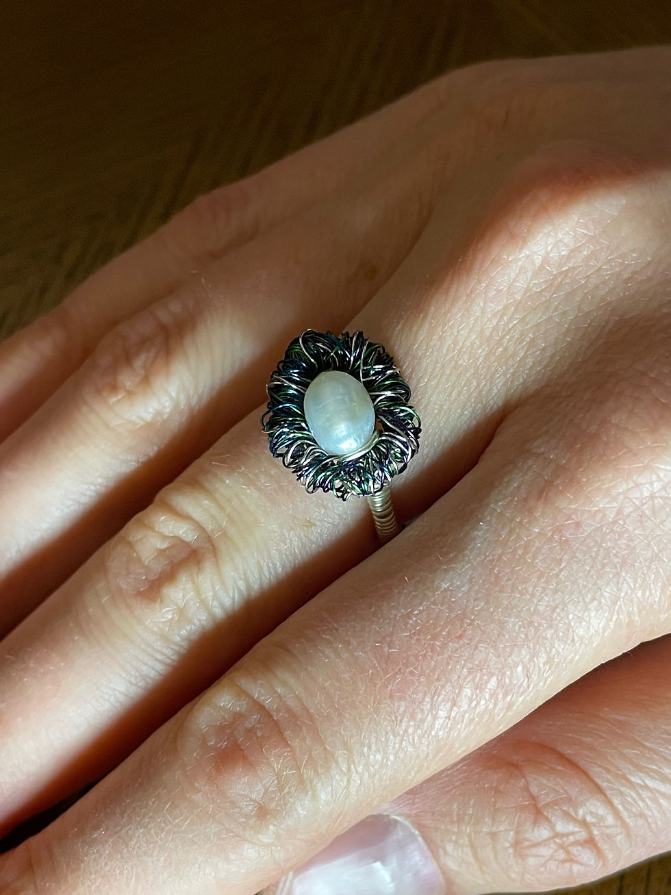 The Peacock Pearl ring, shown worn