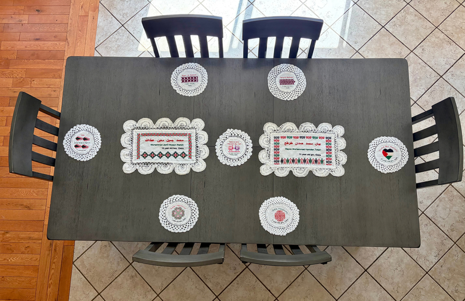 Doilies embroidered with Tatreez motifs and the names of children killed in Gaza, laid across a standard dining table, the place where children gather and where their absence is felt most.