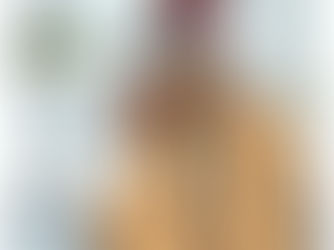 A woman with red hair a winter hat and glasses is at an airport during a snow storm