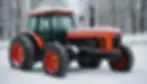 Red tractor covered in snow, parked in a snowy field with bare trees in the background. Peaceful winter scene, no visible text.