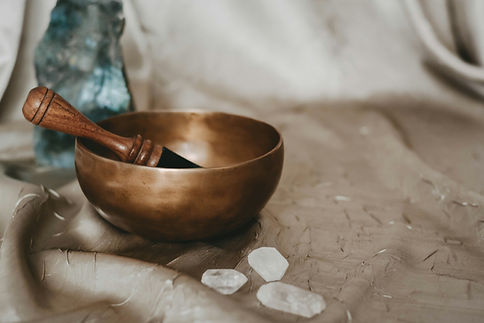 Singing bowl with crystals on a plain sheet