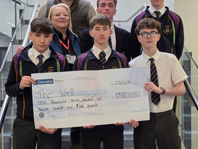Year 11 boys present fundraising cheque to The Well