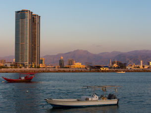Panorama of a Ras al Khaimah View the mountains and city as the sun sets on the Hajar Mountains.