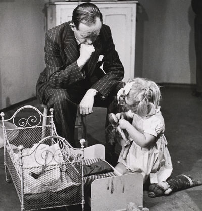 black and white photo of man and girl with baby toys