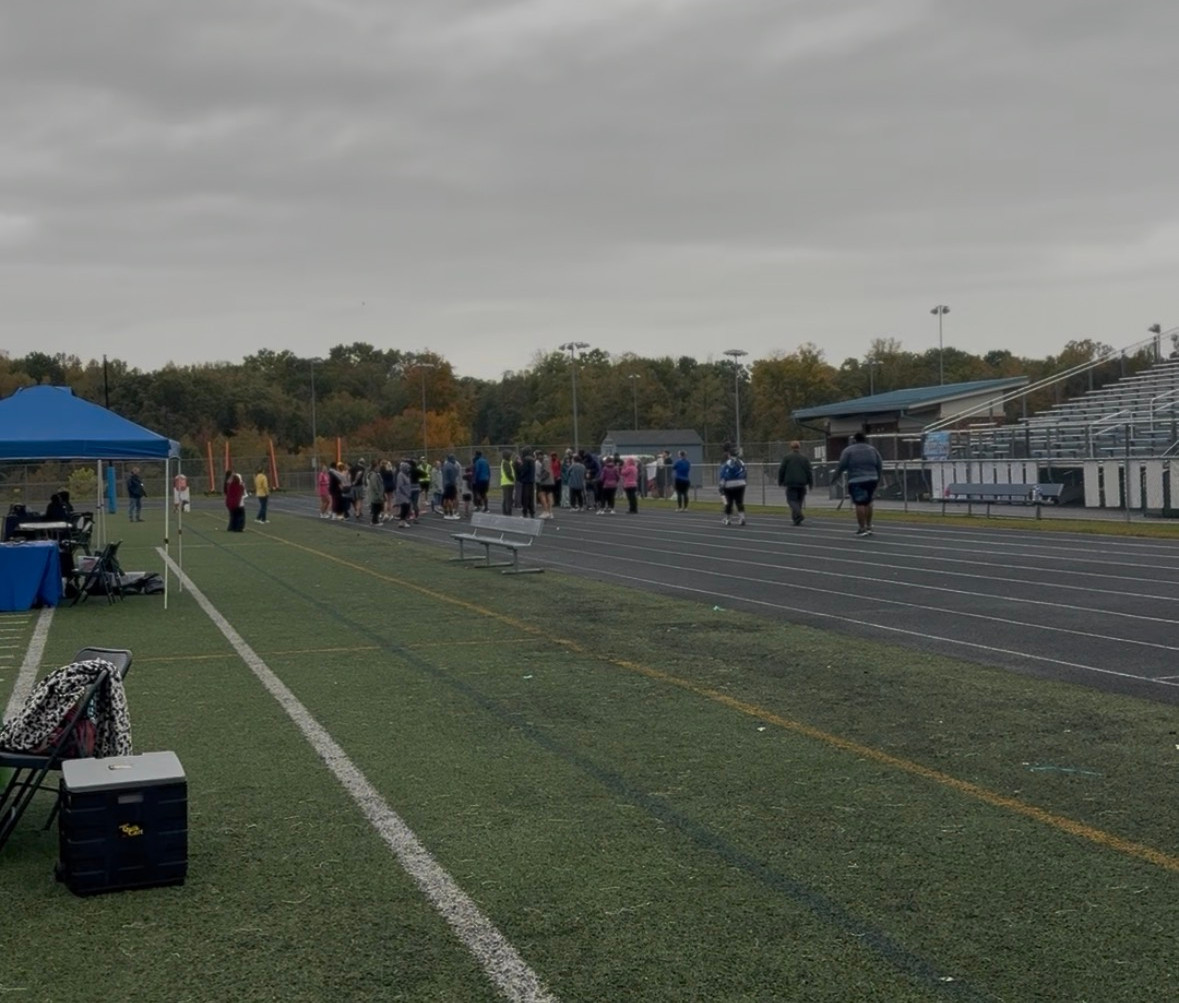 Despite the rain and cold weather, eager participants prepare to start the race.