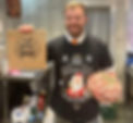 Butcher holding eco bag with support your local butcher branding.