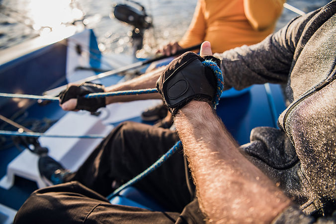 man pulling ropes sailing watersports