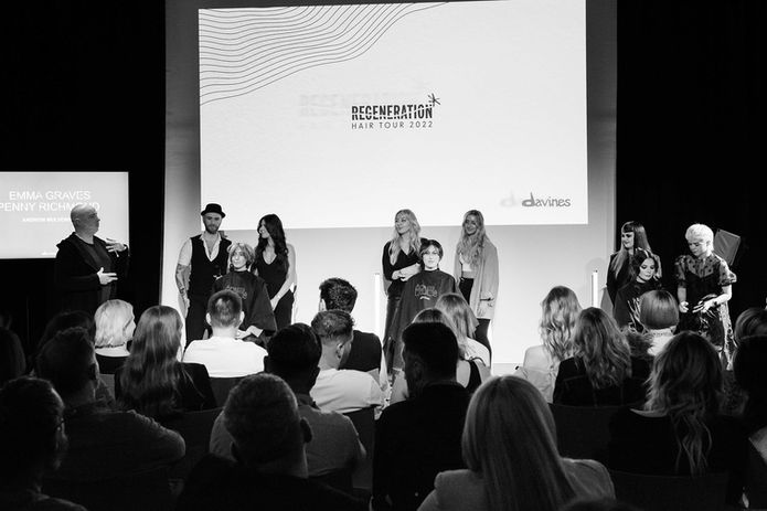 Regeneration logo branding projected on stage at Davines hair tour