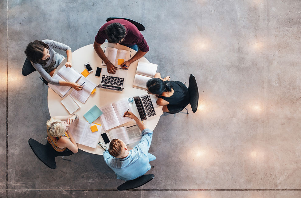 Top view of group of students sitting together at table. University students doing group s