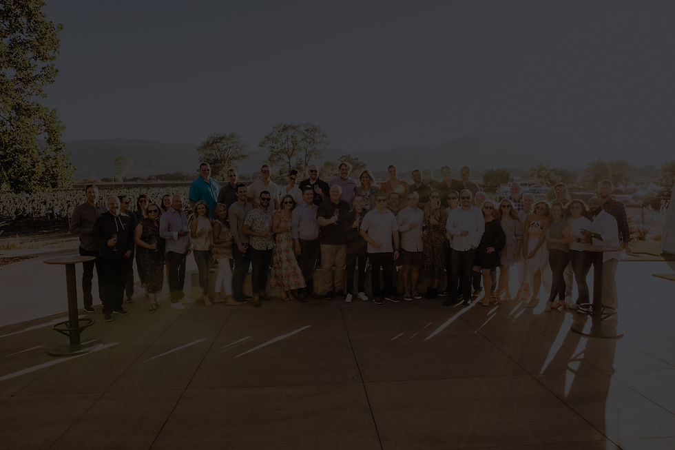 Pharmaceutical team together with gorgeous vineyards behind them in Sonoma, California.