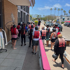 Corporate meeting and retreat attendees on the beach after kayaking Del Mar, California at L'Auberge