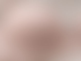 Close-up of a neutral-toned bra cup showing stitching, structure, and fabric detail in soft natural light