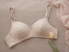 Soft neutral maternity bra in beige tones with delicate fabric details in a calm editorial setting