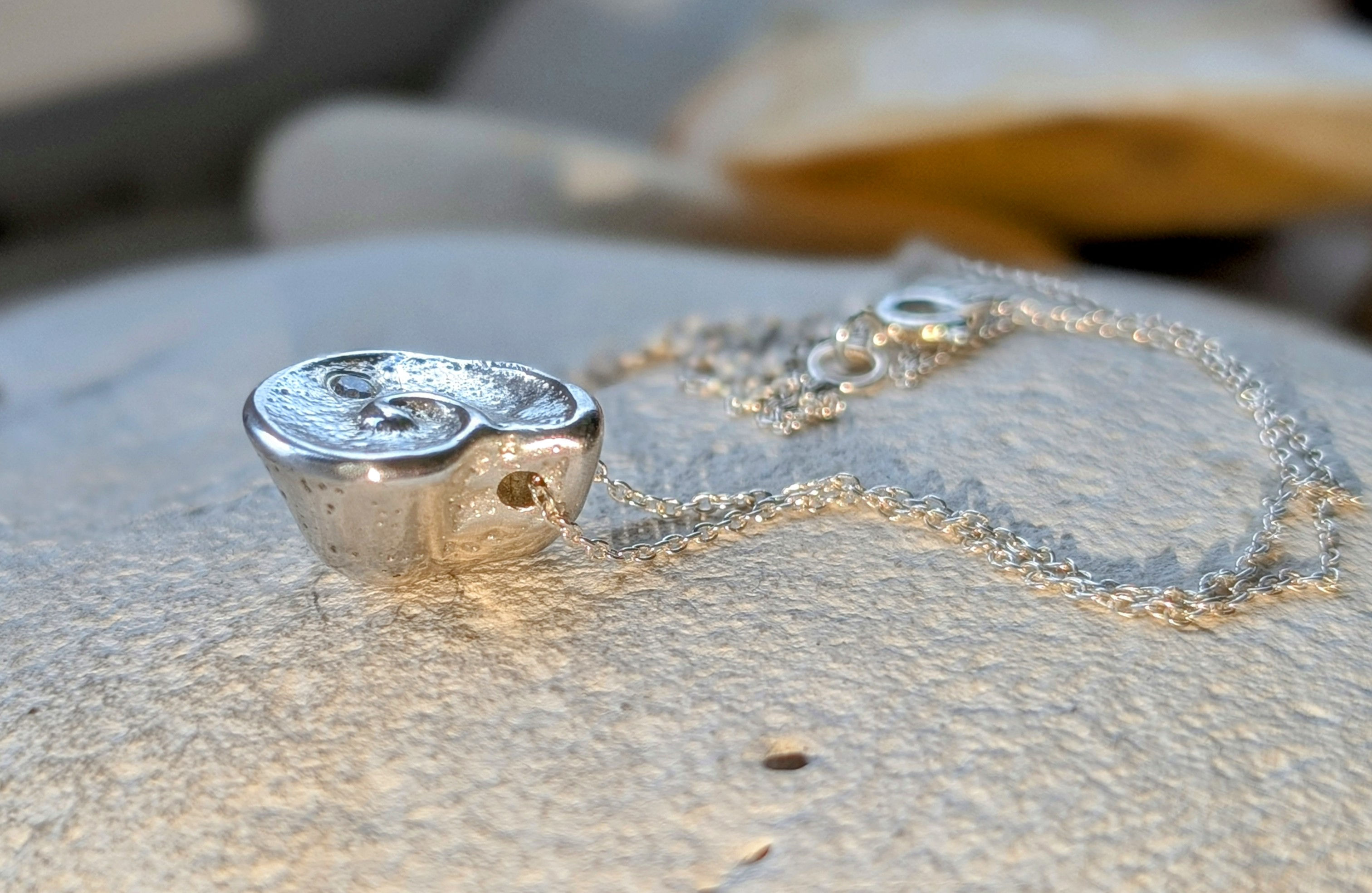 Solid silver and diamond seashell necklace.