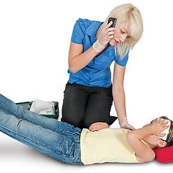 Woman treating an injured person during first aid training