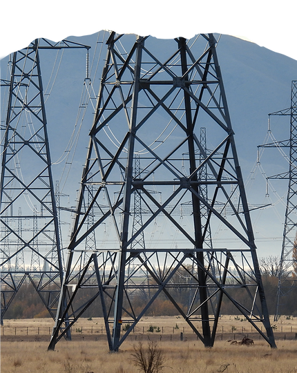 Close-up of a steel pylon tower structure for transmission line design against a clear blue sky.