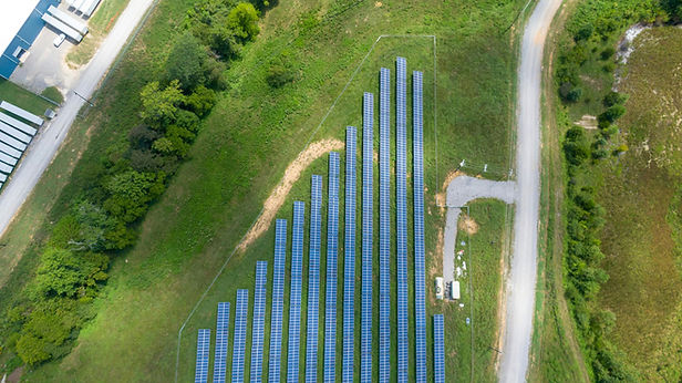 Large-scale solar panels on a field, demonstrating a commercial solar feasibility study project