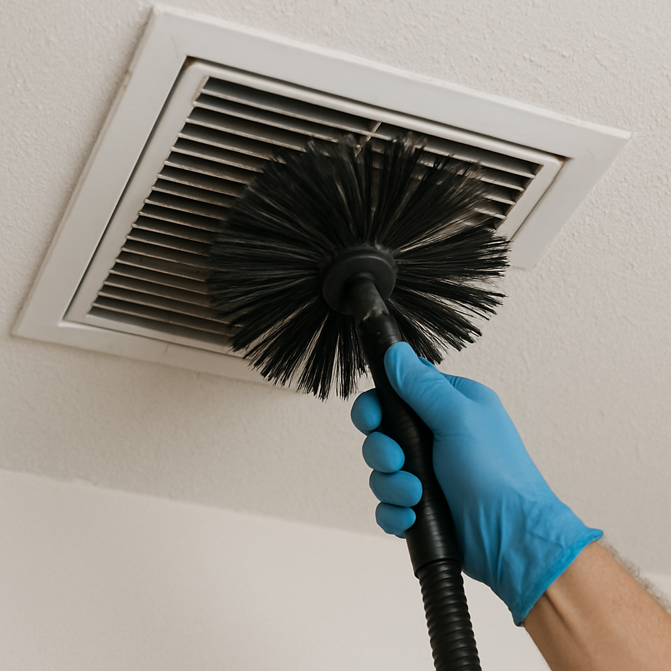Gloved hand cleaning an air vent with a round brush. White ceiling background. Blue glove contrasts with black brush.