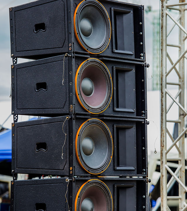 Stadium speakers rack over a blue sky. Live music background. Horizontal.jpg