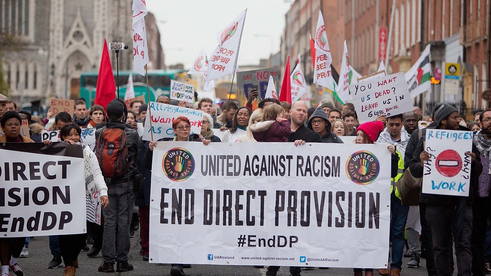 Image of protest calling for an end to Direct Provision at the Garden of Remembrance in Dublin